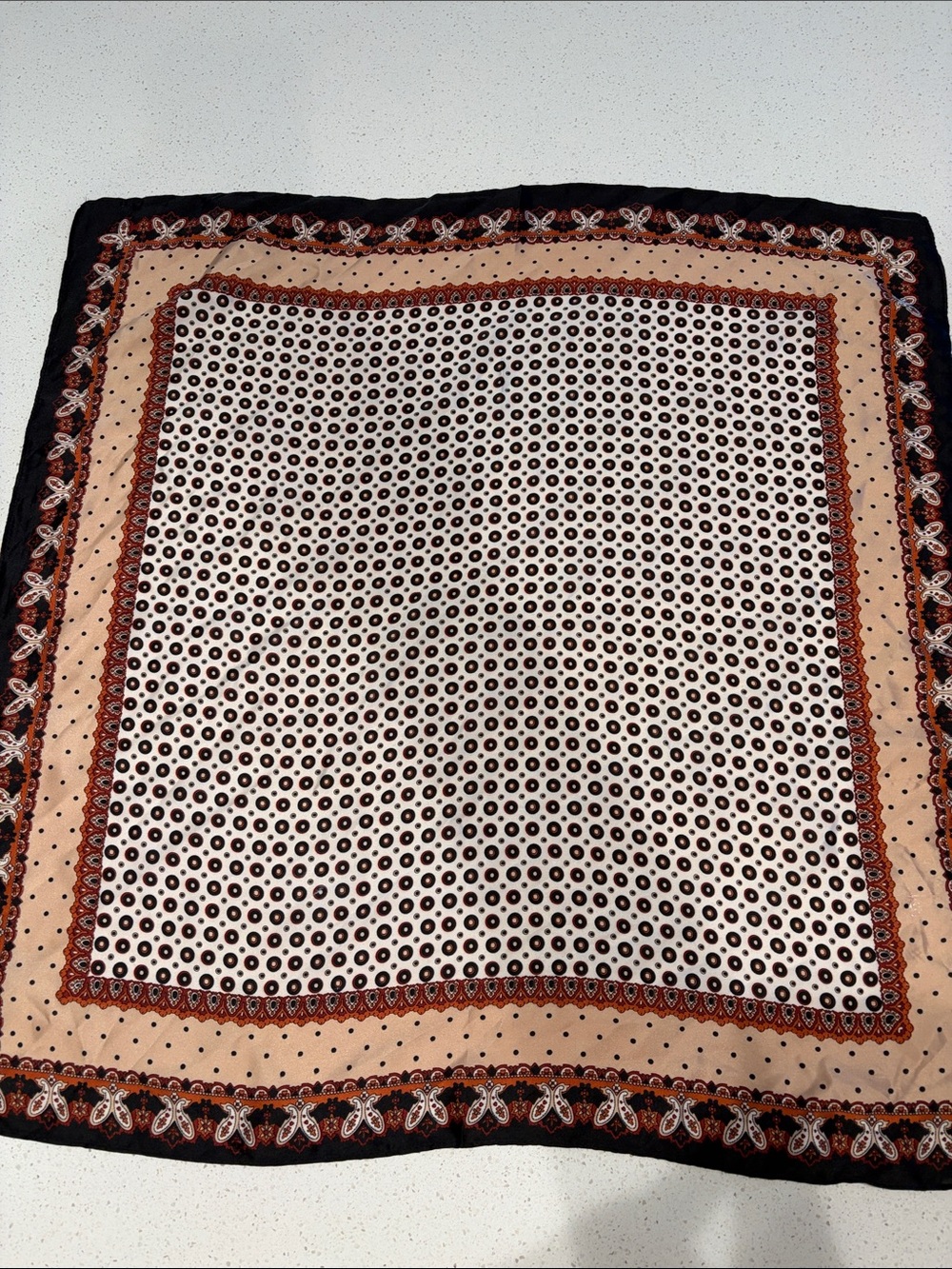 Black, Orange and Tan paisley scarf.  100% washable polyester.
